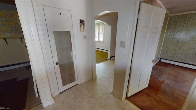 1233 Transylvania Ave, Chesapeake, VA 23324 - hallway featuring arched walkways, a baseboard radiator, and wood walls