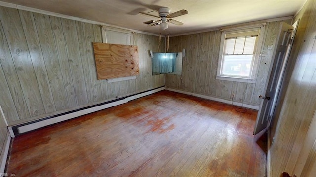 1233 Transylvania Ave, Chesapeake, VA 23324 - unfurnished room with a ceiling fan, baseboard heating, wood finished floors, and wood walls
