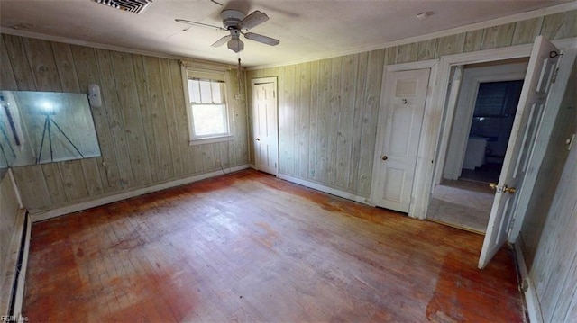 1233 Transylvania Ave, Chesapeake, VA 23324 - unfurnished bedroom featuring wood finished floors, wood walls, baseboards, ornamental molding, and a ceiling fan