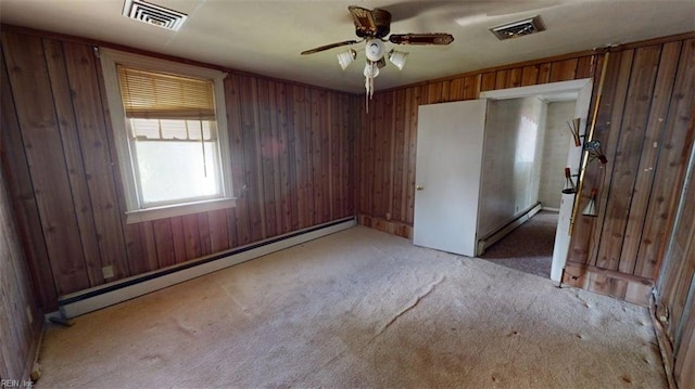 1233 Transylvania Ave, Chesapeake, VA 23324 - unfurnished room featuring a baseboard heating unit, a ceiling fan, light carpet, and wooden walls