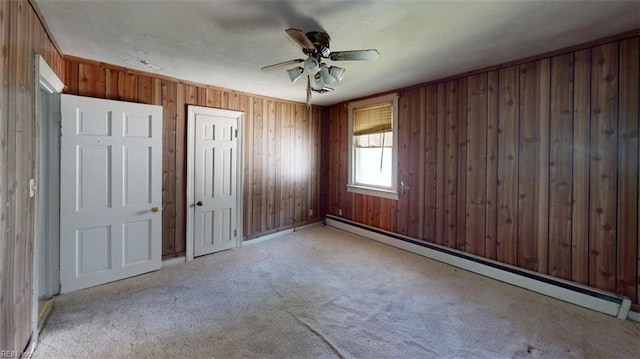 1233 Transylvania Ave, Chesapeake, VA 23324 - carpeted spare room featuring a baseboard heating unit, a ceiling fan, and wood walls