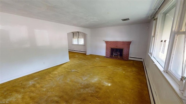1233 Transylvania Ave, Chesapeake, VA 23324 - unfurnished living room featuring baseboard heating, a fireplace, baseboards, and arched walkways