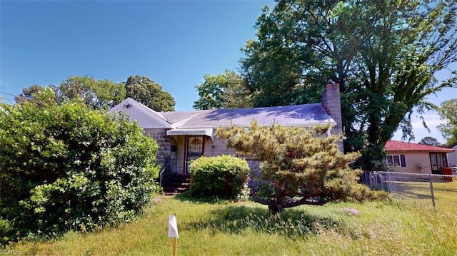 1233 Transylvania Ave, Chesapeake, VA 23324 - view of front of home with fence and a chimney