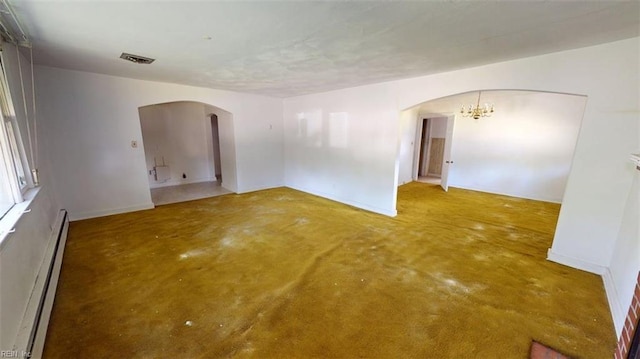 1233 Transylvania Ave, Chesapeake, VA 23324 - spare room with arched walkways, baseboard heating, a chandelier, and concrete flooring