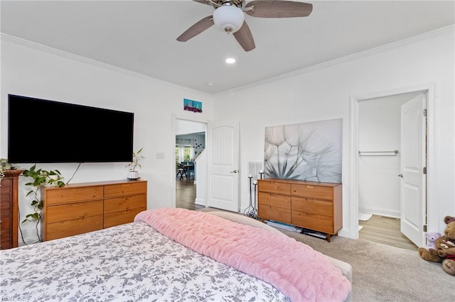 carpeted bedroom featuring recessed lighting, ornamental molding, and a ceiling fan