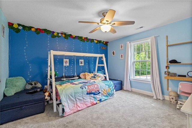 carpeted bedroom with a ceiling fan, baseboards, and visible vents