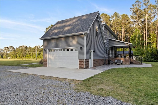 view of side of property with covered porch, a garage, gravel driveway, a yard, and a shingled roof