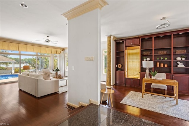 interior space featuring crown molding, baseboards, ceiling fan, and granite finish floor