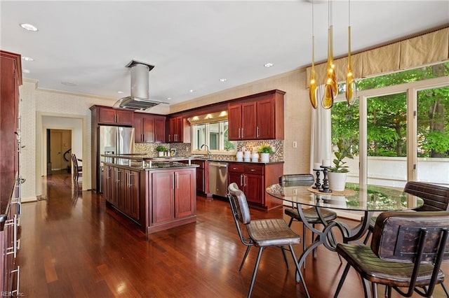 kitchen with a kitchen island, crown molding, dark countertops, reddish brown cabinets, and stainless steel appliances