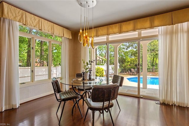 dining space with an inviting chandelier and wood finished floors