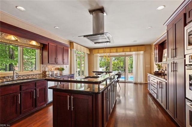 kitchen featuring a sink, a center island, and a wealth of natural light