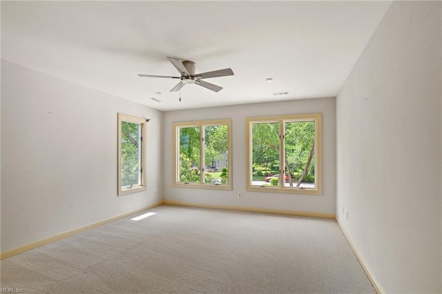empty room with baseboards, carpet flooring, and a ceiling fan