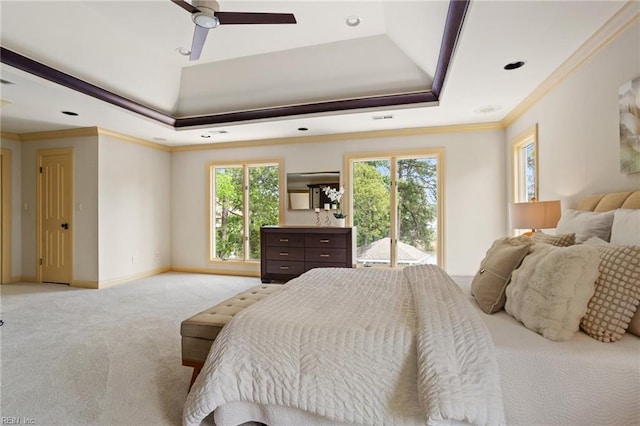 bedroom featuring baseboards, ornamental molding, a raised ceiling, and light carpet