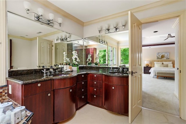 bathroom featuring crown molding, double vanity, a sink, and connected bathroom