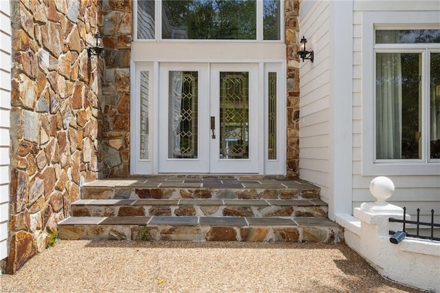 view of exterior entry with french doors and stone siding