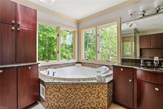 bathroom with crown molding, a bath, and vanity