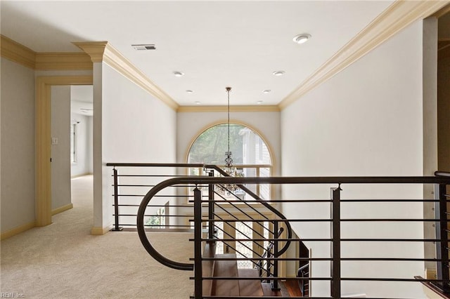 stairway with carpet flooring, an inviting chandelier, baseboards, visible vents, and ornamental molding