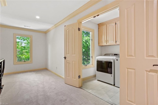 laundry area featuring visible vents, washer and dryer, light carpet, baseboards, and cabinet space