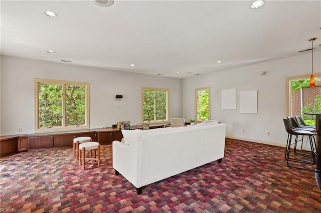 carpeted living room featuring baseboards and recessed lighting