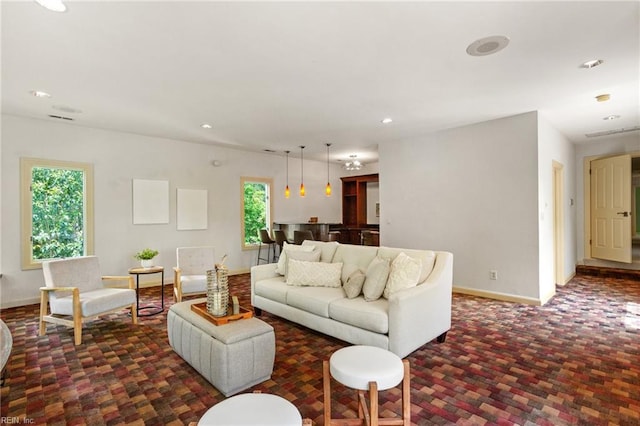 living room featuring recessed lighting, baseboards, and dark carpet