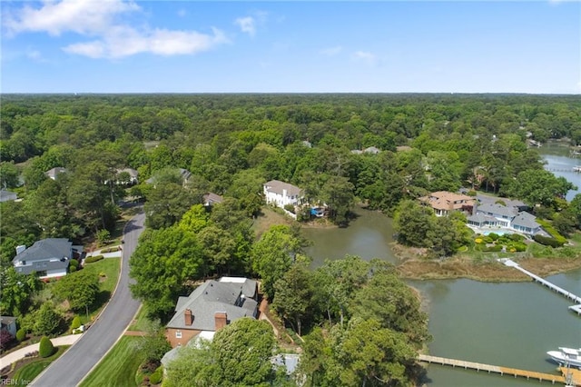 aerial view with a water view and a forest view
