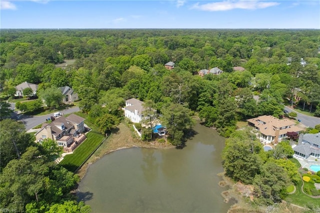 birds eye view of property featuring a water view and a view of trees