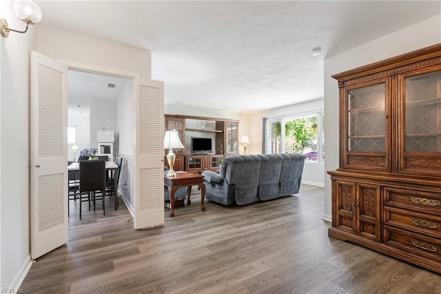 living room featuring baseboards and wood finished floors