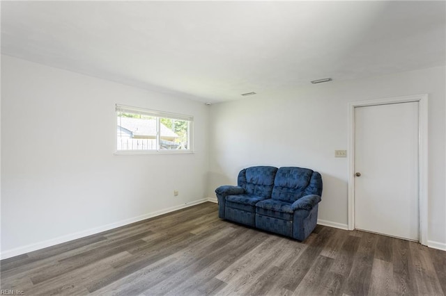 sitting room featuring baseboards, wood finished floors, and visible vents
