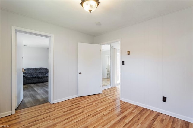 unfurnished bedroom featuring baseboards and light wood-type flooring