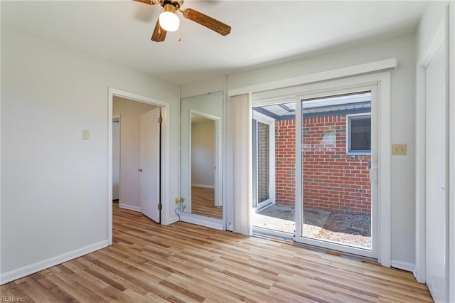 empty room with a ceiling fan, baseboards, and light wood-style flooring