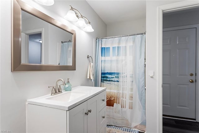 bathroom with vanity, wood finished floors, and curtained shower