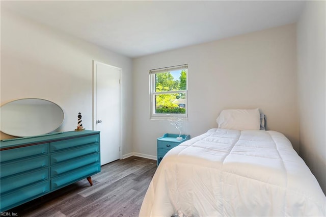 bedroom featuring baseboards and wood finished floors