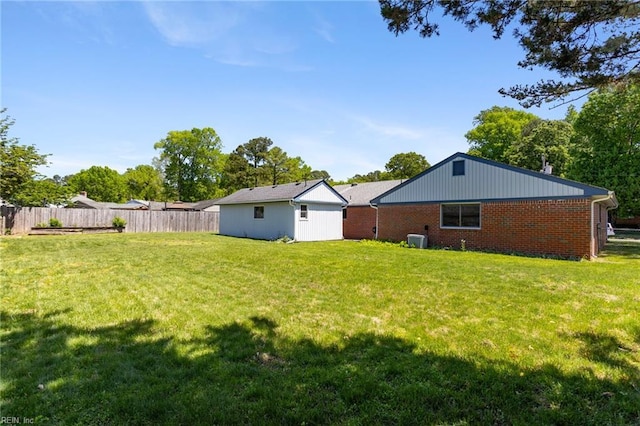 view of yard with fence and cooling unit