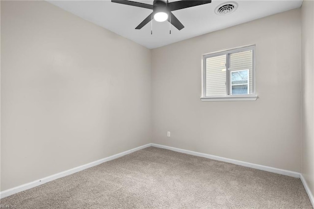 carpeted empty room with visible vents, baseboards, and ceiling fan