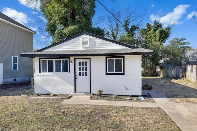 view of outbuilding featuring fence