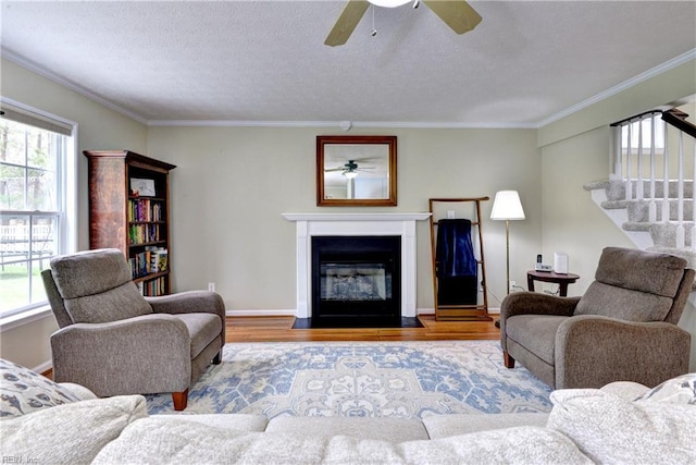 109 Van Curen Ct, Yorktown, VA 23693 - living room featuring crown molding, ceiling fan, wood finished floors, and stairway
