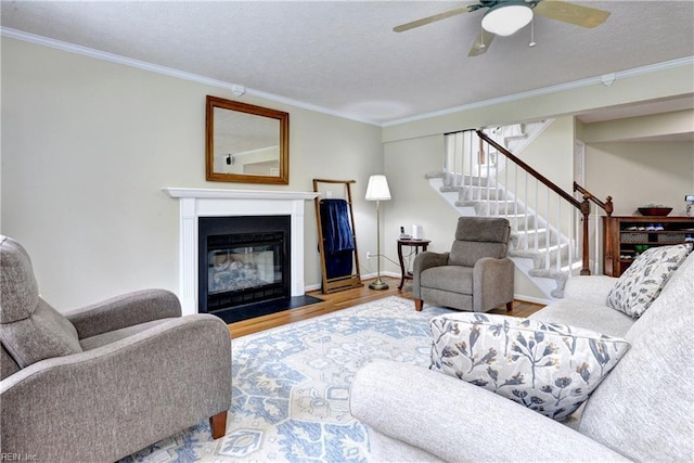 109 Van Curen Ct, Yorktown, VA 23693 - living room with ceiling fan, a fireplace with flush hearth, crown molding, wood finished floors, and stairway
