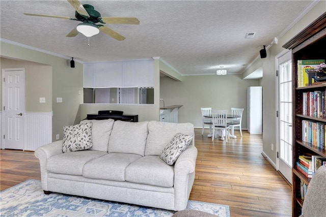 109 Van Curen Ct, Yorktown, VA 23693 - living area with a ceiling fan, a textured ceiling, ornamental molding, and wood finished floors
