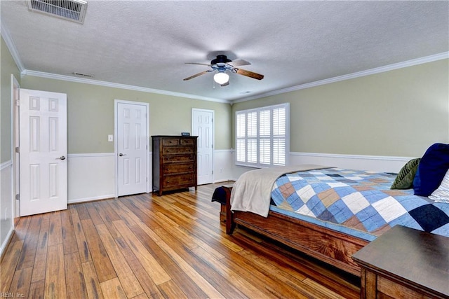 109 Van Curen Ct, Yorktown, VA 23693 - bedroom featuring crown molding, wood-type flooring, a textured ceiling, and visible vents