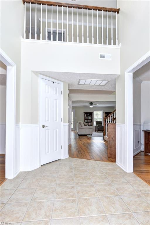 109 Van Curen Ct, Yorktown, VA 23693 - tiled entryway featuring visible vents, a towering ceiling, and a wainscoted wall
