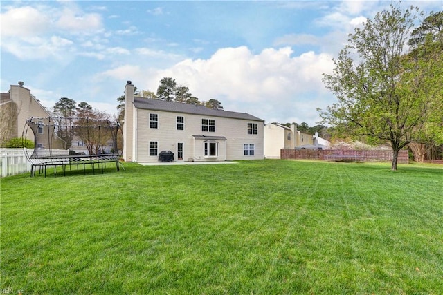 109 Van Curen Ct, Yorktown, VA 23693 - back of property with a yard, a chimney, a fenced backyard, and a trampoline