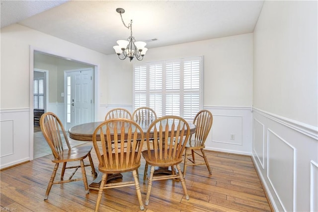 109 Van Curen Ct, Yorktown, VA 23693 - dining room featuring a decorative wall, wainscoting, hardwood / wood-style floors, and a chandelier