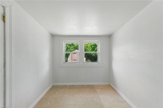 unfurnished room featuring baseboards