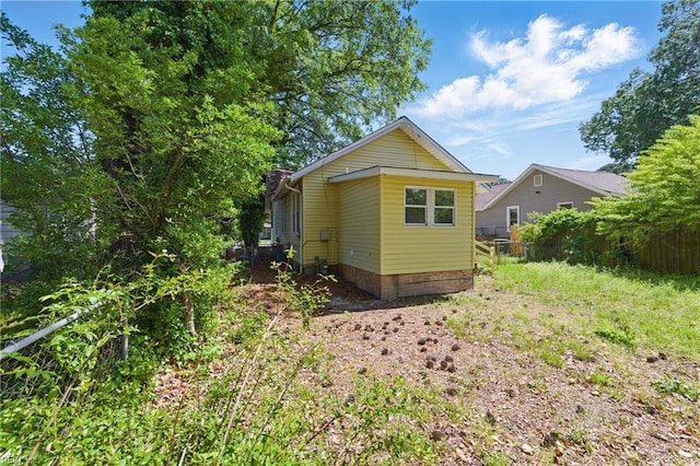 back of house featuring fence