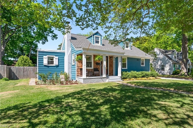 cape cod home with a porch, fence, and a front lawn