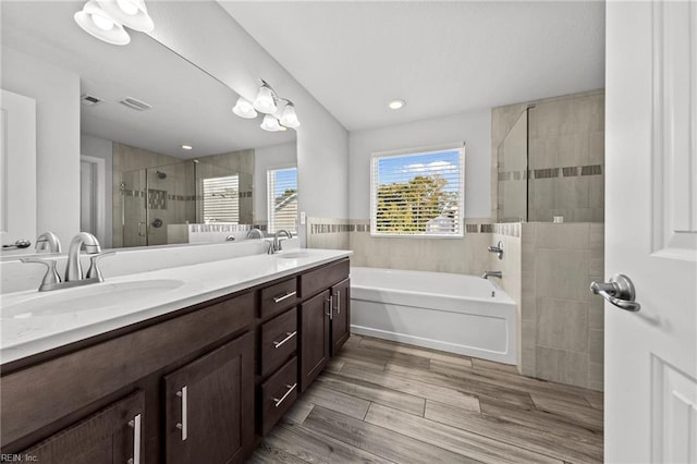 2848 Kingsfield Dr, Virginia Beach, VA 23456 - full bath featuring a garden tub, double vanity, wood finished floors, a shower stall, and a sink