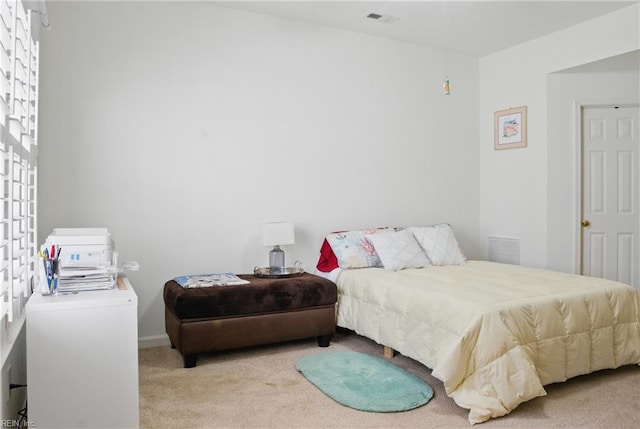 carpeted bedroom with baseboards and visible vents
