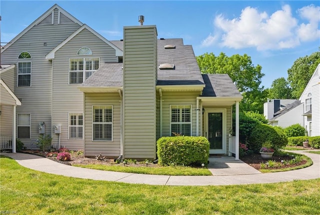 exterior space featuring a chimney and a front lawn