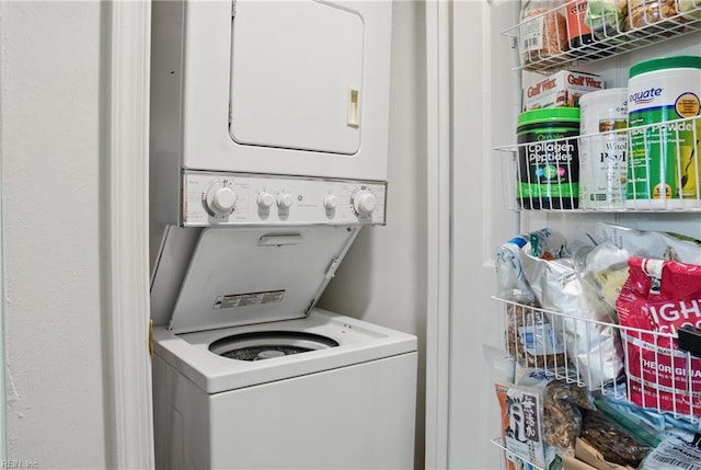 washroom featuring laundry area and stacked washer / dryer