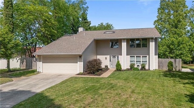 view of front of property featuring a chimney, a front yard, fence, concrete driveway, and an attached garage